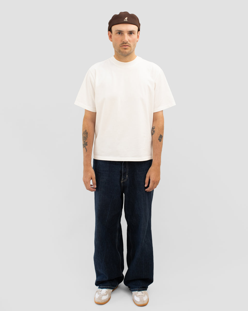 Model wearing Braddyll statement tee in white with cropped fit, french seam and single stitching seen from the front