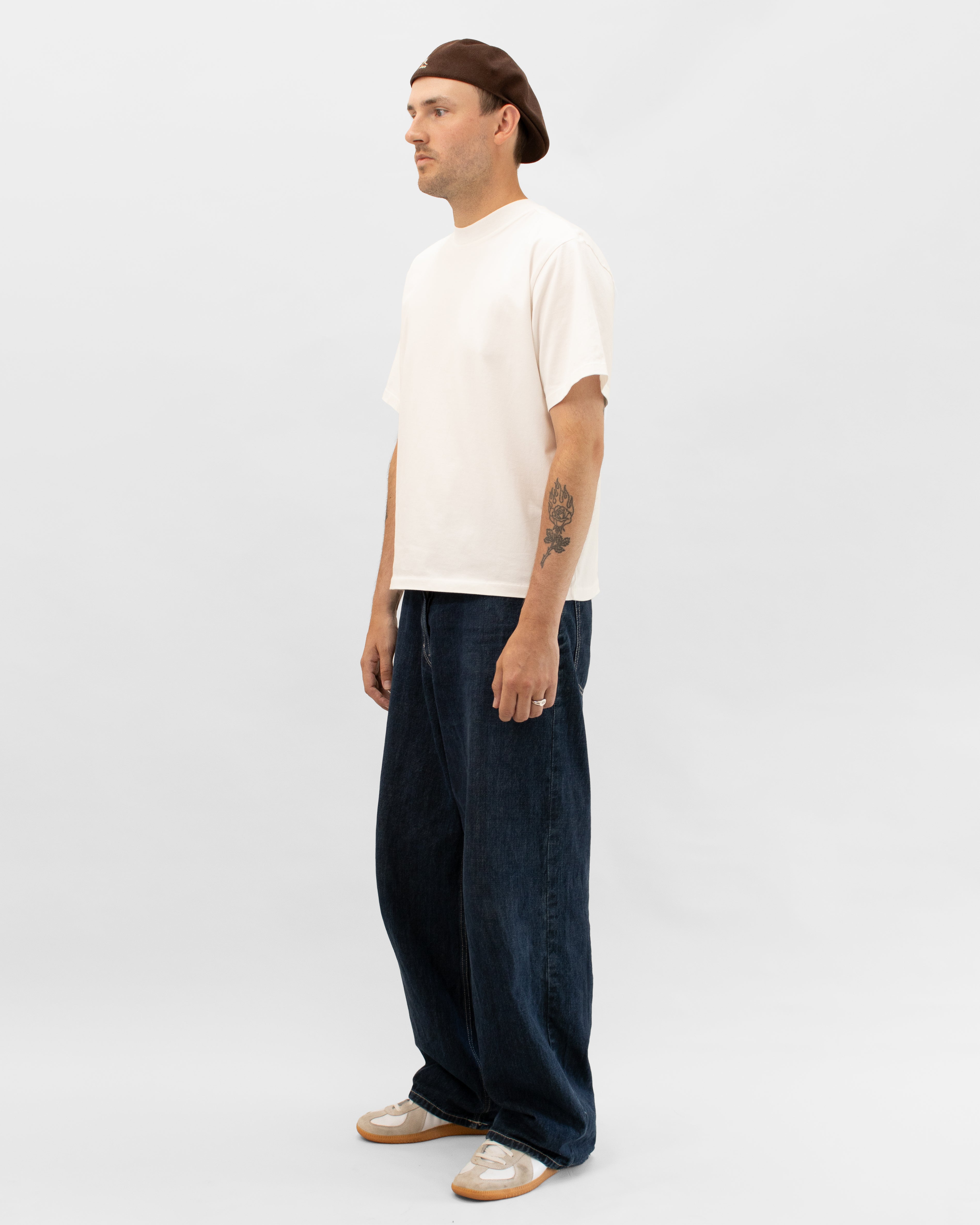 Model wearing Braddyll statement tee with cropped fit, french seam and single stitching seen from the side